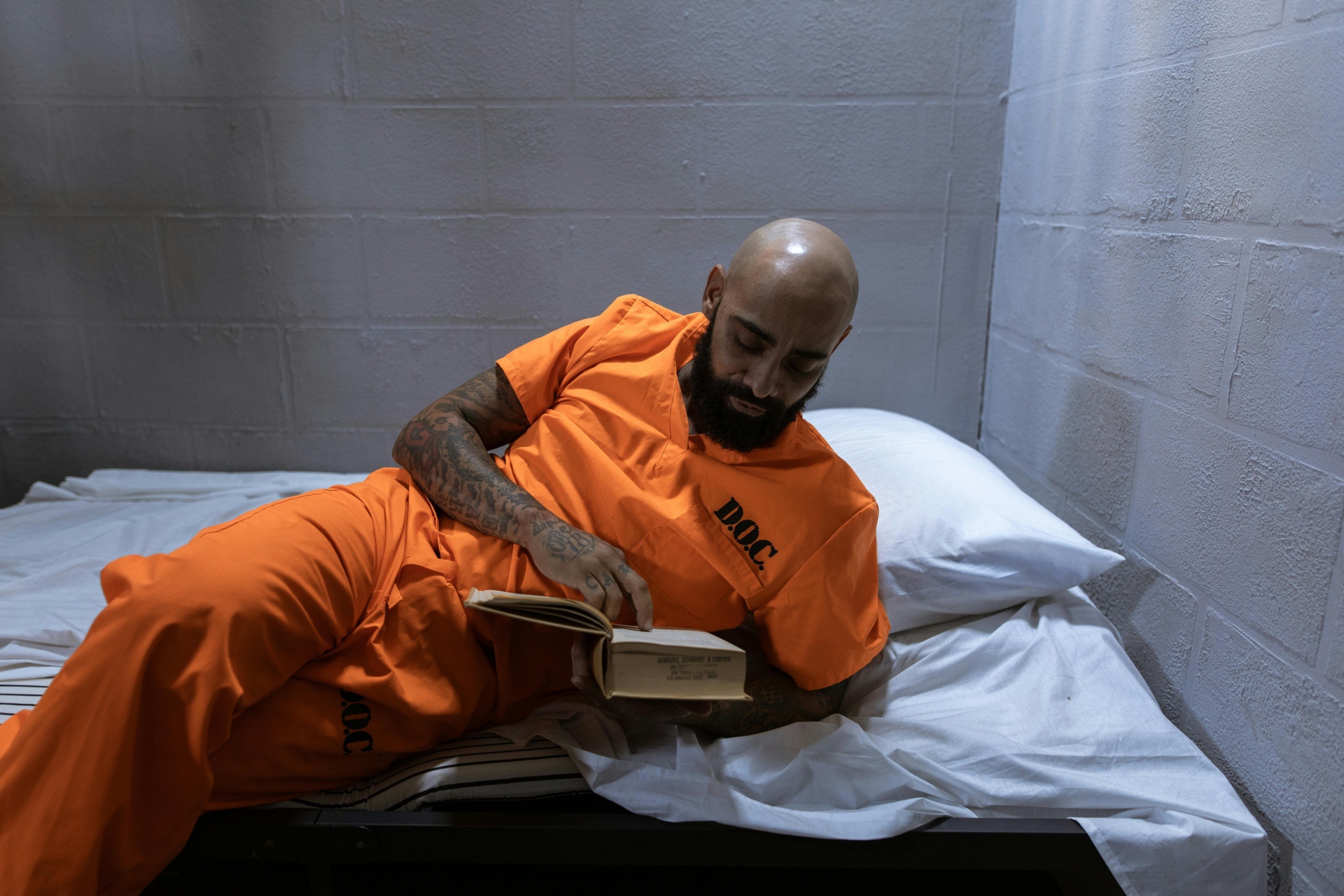 Prisoner reading book in prison
