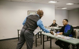 Teacher Giving the Forms to the students