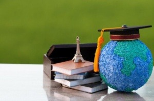 A stack of books with a graduation cap on top, and a globe beside it. This image represents the Second Chance Scholarship Foundation's mission of providing educational opportunities to students from diverse backgrounds who are overcoming challenges.